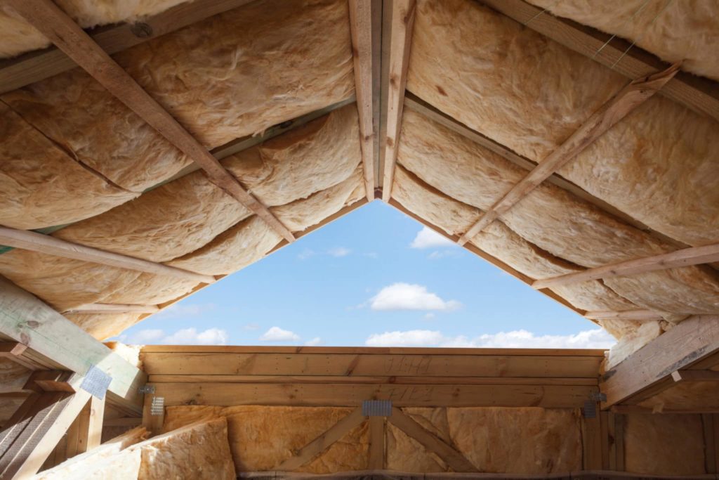 Fibreglass insulation installed in the sloping ceiling of a new frame house.