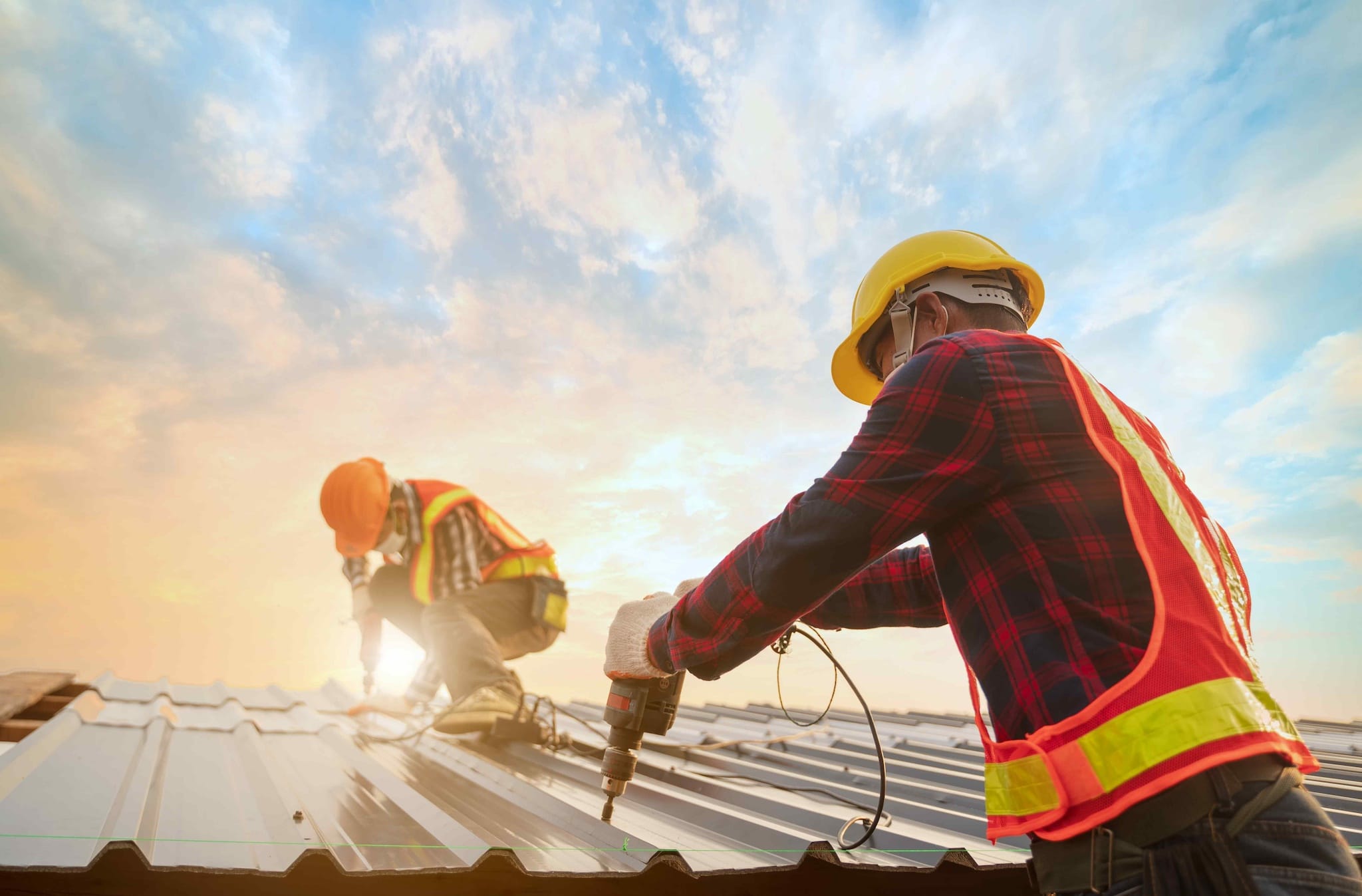 Roofing installer using one of many types of commercial roofing.