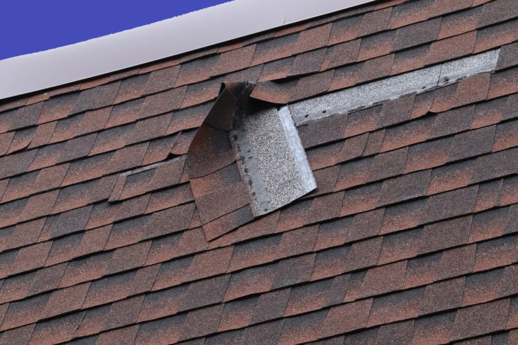 Damaged Brown Roof Shingle - Wind Damage