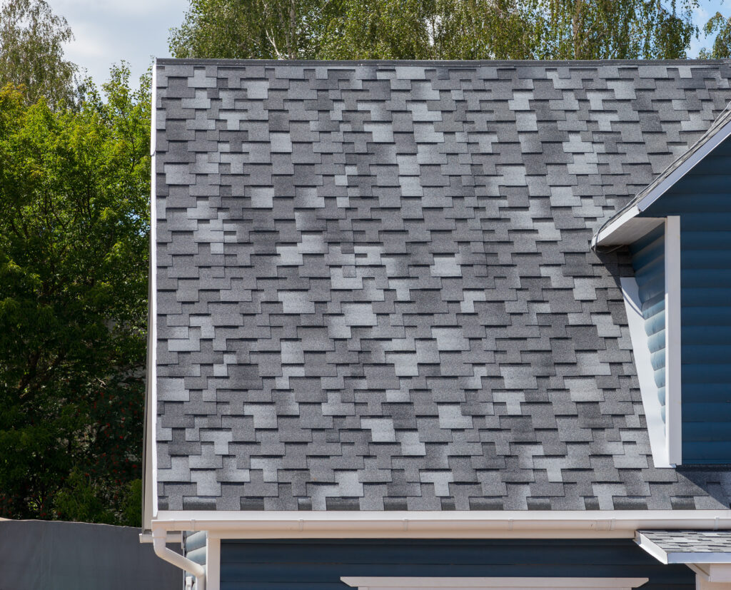 The roof of the house lined with gray bitumen shingles