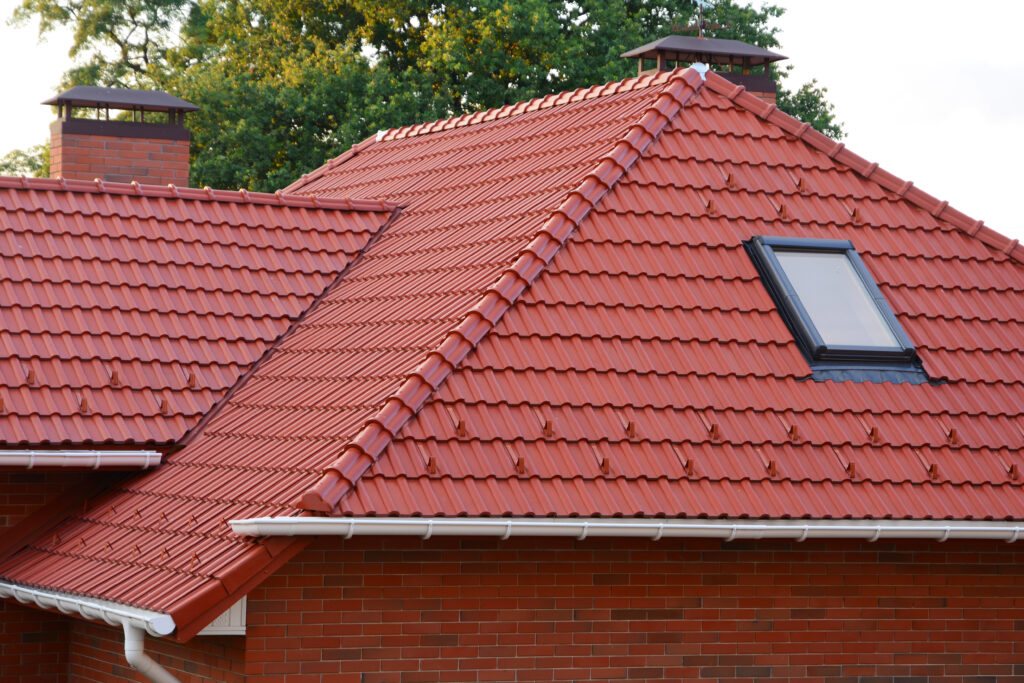 New Red Shingles Roof with Skylights Windows and Rain Gutter. 